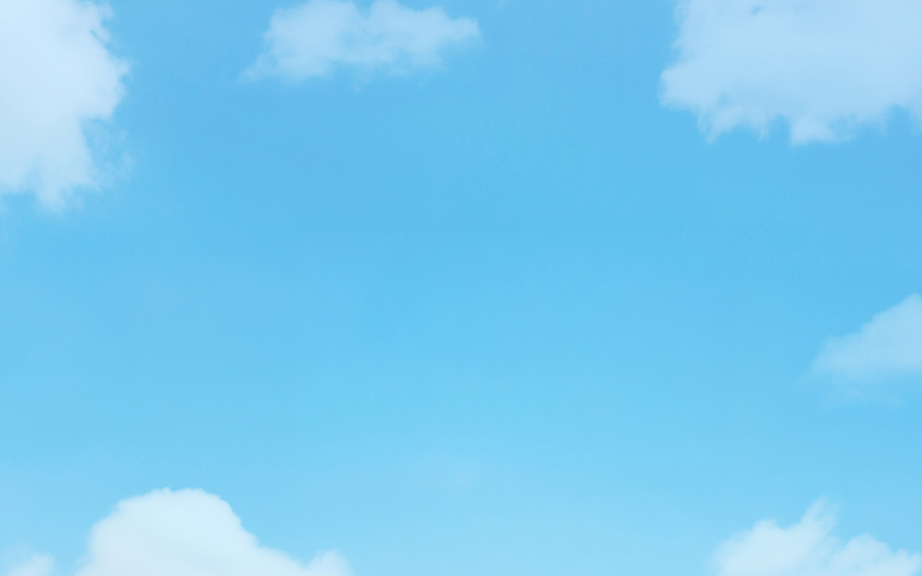A bright blue sky filled with soft clouds